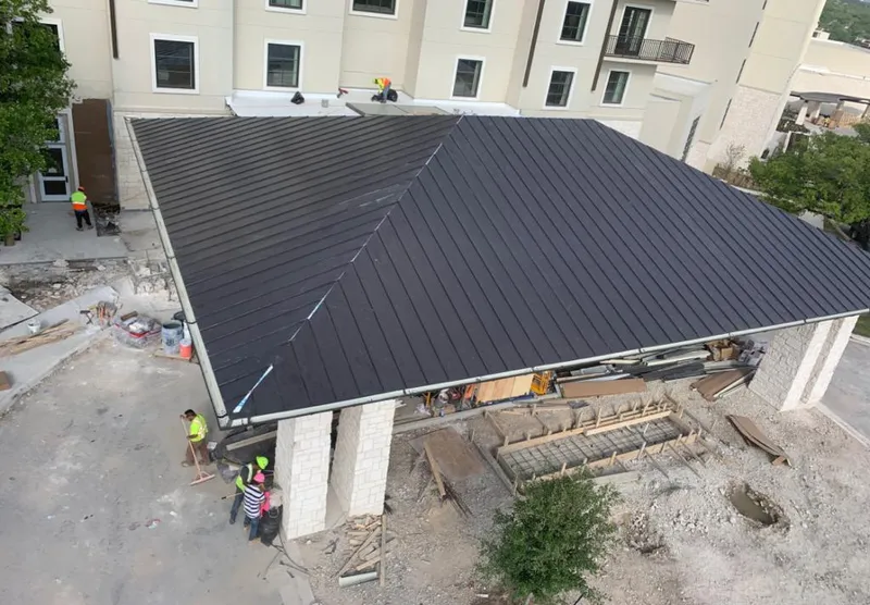 Metal roofing installation team working on a commercial building in Ontario